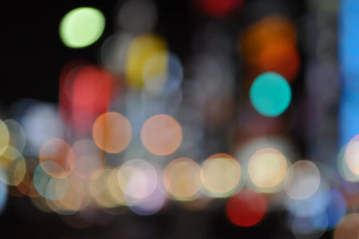 Blurred colourful city lights forming soft bokeh circles at night